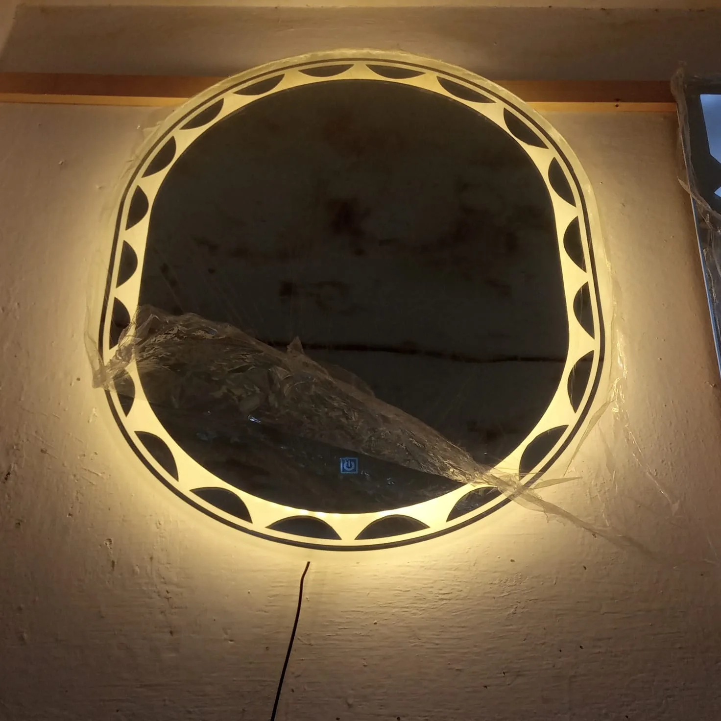 Pill shaped capsule LED mirror with illuminated scalloped border and touch sensor