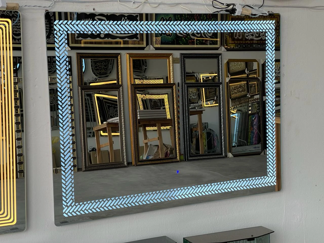 Custom herringbone braided pattern LED mirror with cool white border illumination and smart touch sensor in Sialkot workshop